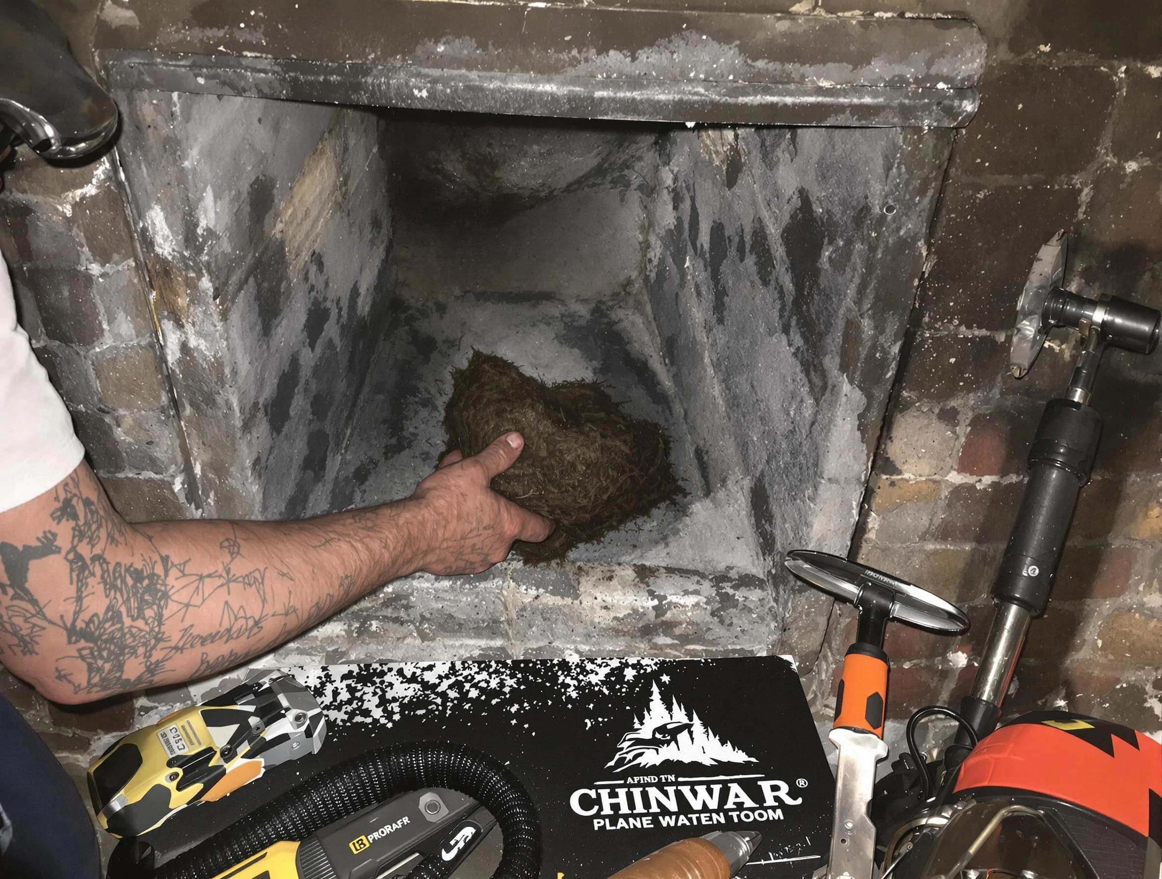 Midfield Chimney Sweep safely removing debris and screening chimney in Midfield, AL